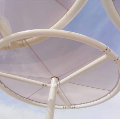 Underside of a circular umbrella shade showing its steel ribs
