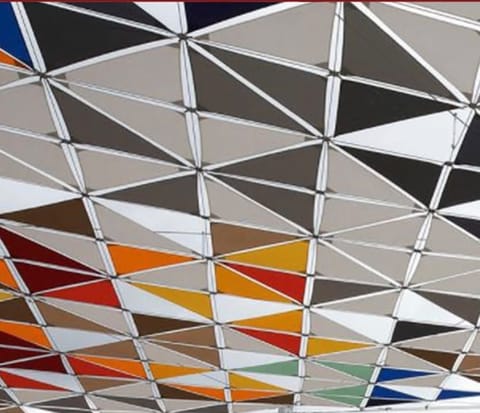 Grey, orange and red triangular panels in a geometric canopy
