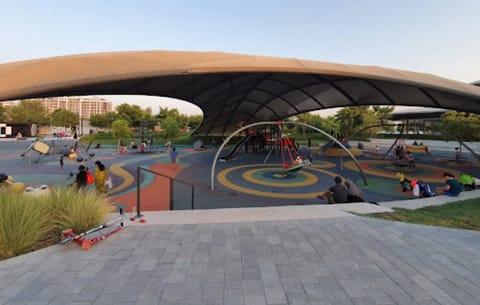 Large free-form tensile roof over a public playground
