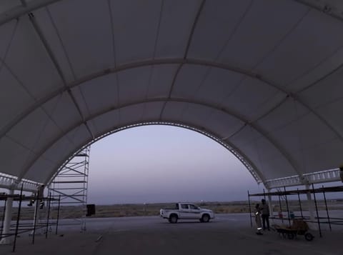 Looking out through the end of a large arched membrane structure