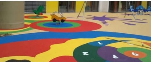 Colourful play flooring with numbers and shapes around play equipment